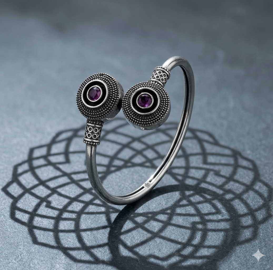 Silver bracelet with purple gemstones on a textured gray background